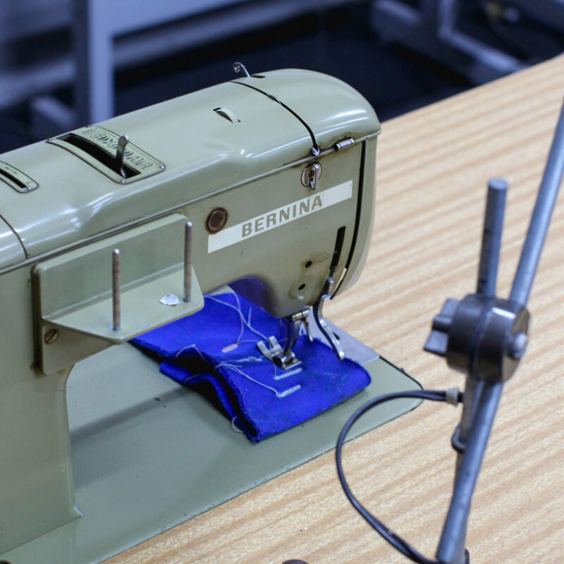 A sewing machine with blue fabric